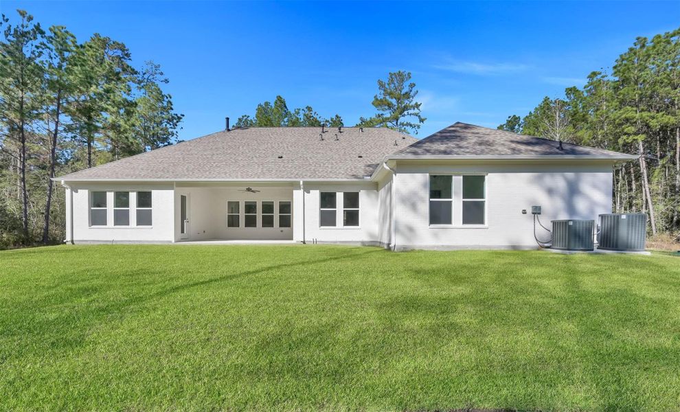 Spacious grass lawn and surrounding trees are pleasant and welcoming on this 2-acre property. Spacious grass lawn and surrounding trees are pleasant and welcoming on this 2-acre property.