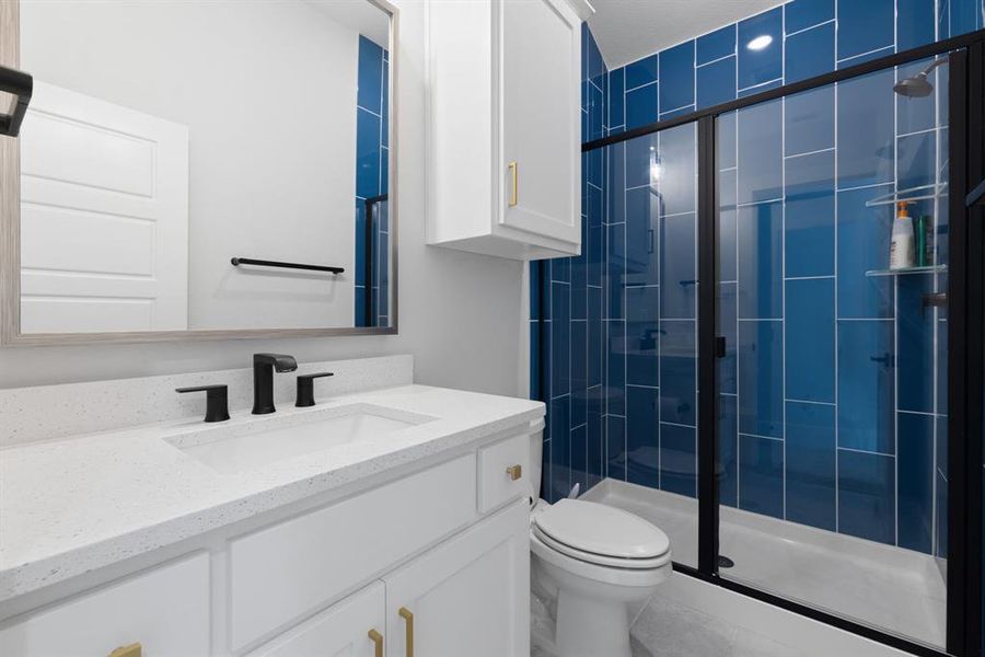Bathroom with vanity, a stall shower, and tile patterned floors
