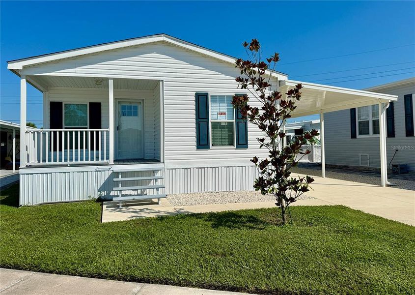 Front exterior of a new home in , Sarasota, FL, highlighting curb appeal (Image 1).