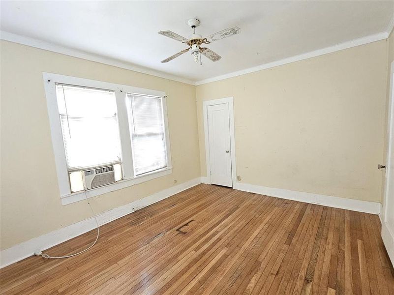 Unfurnished room featuring ceiling fan, cooling unit, hardwood / wood-style flooring Unfurnished room featuring ceiling fan, cooling unit, hardwood / wood-style flooring