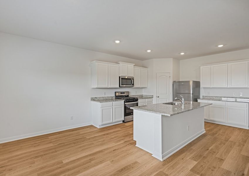 The kitchen island overlooks the family room