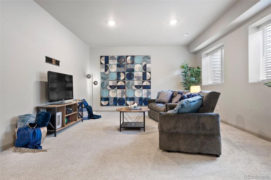 Ideal finished lower level for movie nights, game nights, hobbies and more