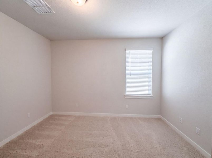 A spacious room offers comfortable carpet flooring and a sun-filled window, ready for personalization. A spacious room offers comfortable carpet flooring and a sun-filled window, ready for personalization.