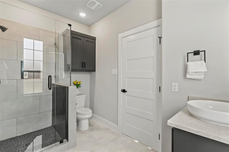 Bathroom featuring vanity and a shower stall Bathroom featuring vanity and a shower stall