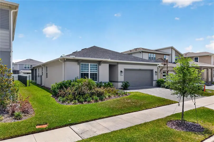 Front exterior of a new home in EverBe, Orlando, FL, highlighting curb appeal (Image 25). Front exterior of a new home in EverBe, Orlando, FL, highlighting curb appeal (Image 25).