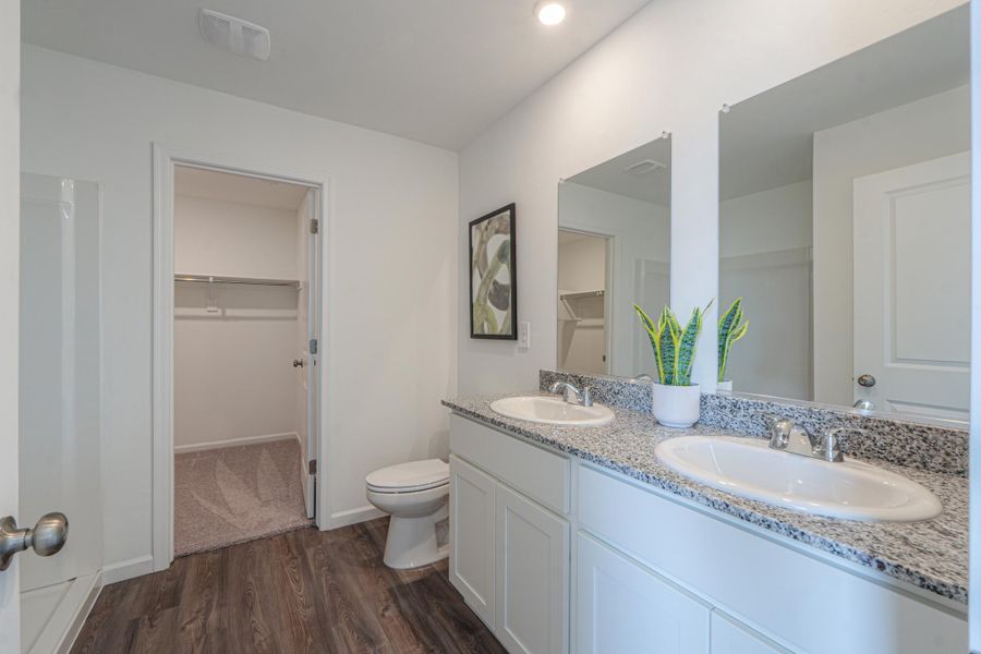 A bathroom with a sink toilet and a shower.