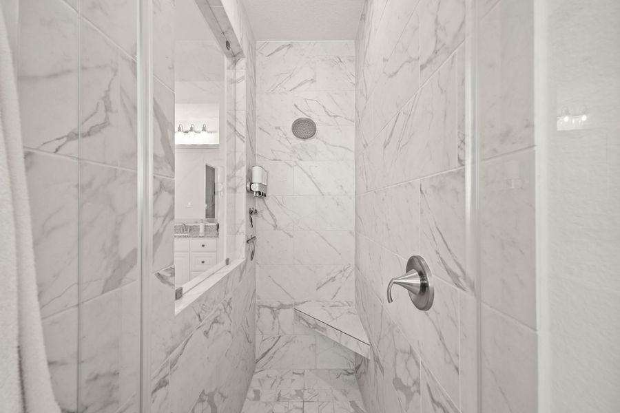 Relax and unwind in the walk-in shower, finished with floor to ceiling beautiful 12” x 24” tile and a tiled bench.