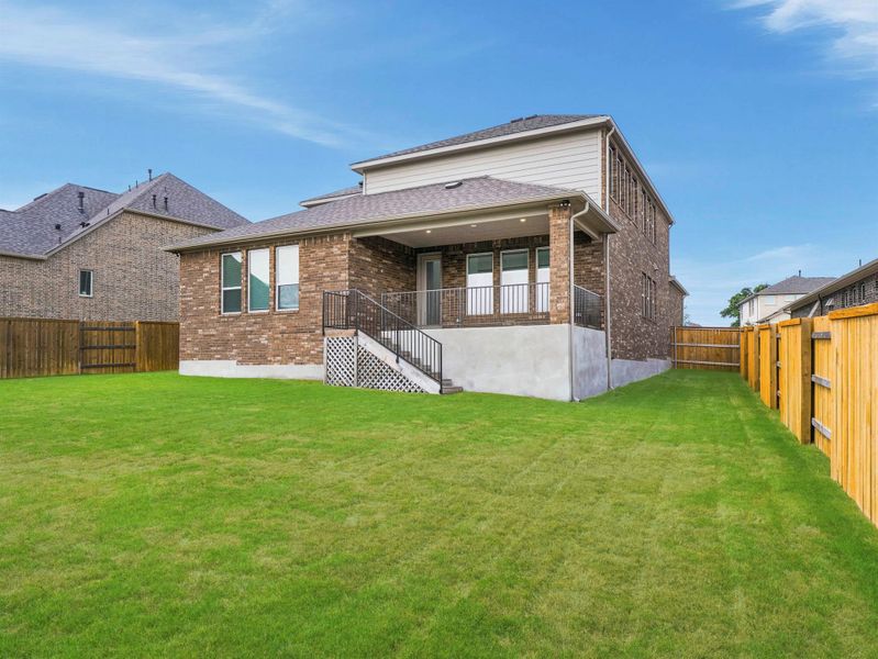 A well-maintained lawn provides a verdant backdrop to this two-story brick home, featuring a covered patio for outdoor enjoyment. A well-maintained lawn provides a verdant backdrop to this two-story brick home, featuring a covered patio for outdoor enjoyment.