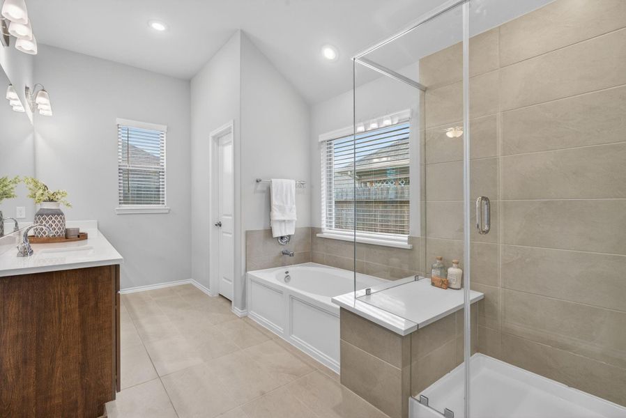 A soaking tub and frameless glass shower are beautiful touches to make this room complete. A soaking tub and frameless glass shower are beautiful touches to make this room complete.