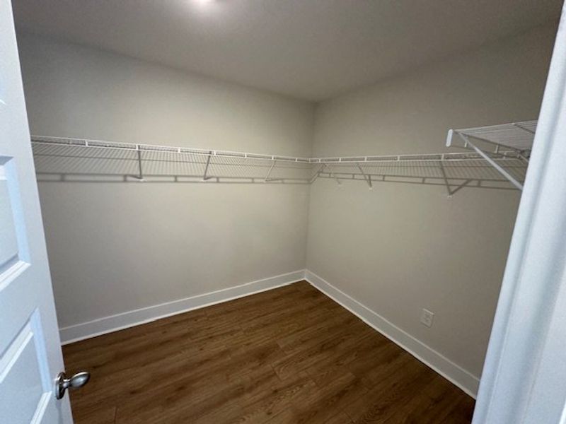 This spacious walk-in closet features ample shelvi