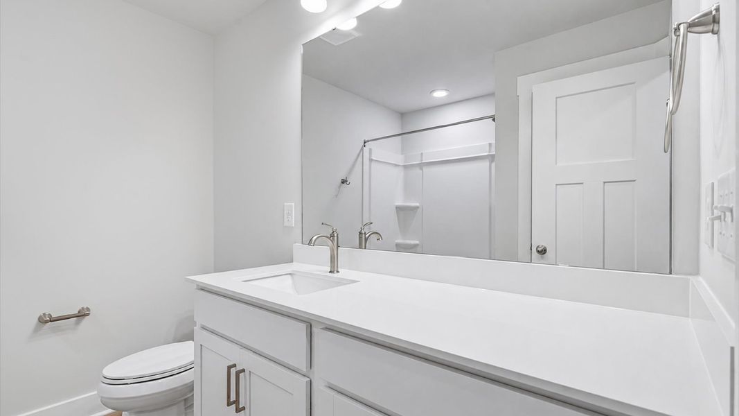 Highly skilled design seen in this polished and practical full bathroom