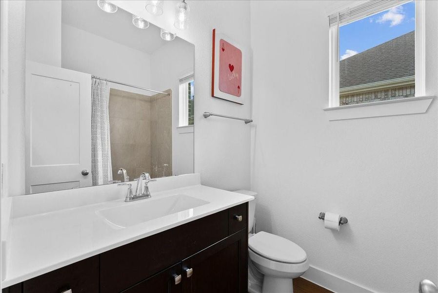 Conveniently located at the front of the home, the guest bathroom features a tub/shower combination and a window that brings in natural light. Conveniently located at the front of the home, the guest bathroom features a tub/shower combination and a window that brings in natural light.