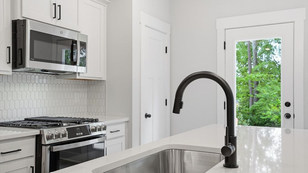 Tasteful kitchen with a streamlined island and modern finishes in a first-class DRB Homes design