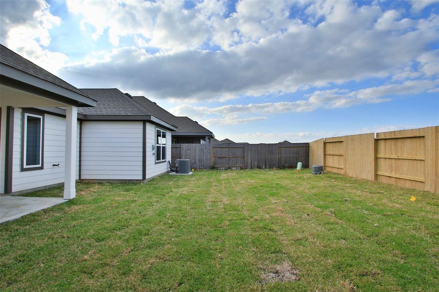 Exterior details and patio area of a home in Sunterra, Katy (Image 19).