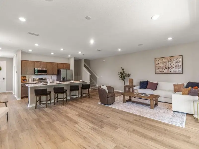 Downstairs, enjoy a sunny open-concept living area - Birch townhome by Highland Homes