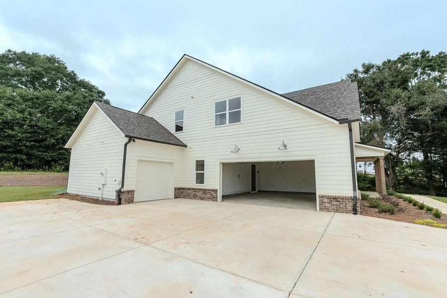 Front exterior of a new home in , Hoschton, GA, highlighting curb appeal (Image 26).