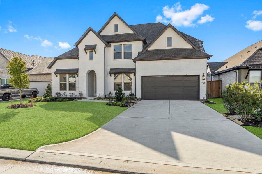 Front exterior of a new home in The Highlands, Porter, TX, highlighting curb appeal (Image 26). Front exterior of a new home in The Highlands, Porter, TX, highlighting curb appeal (Image 26).