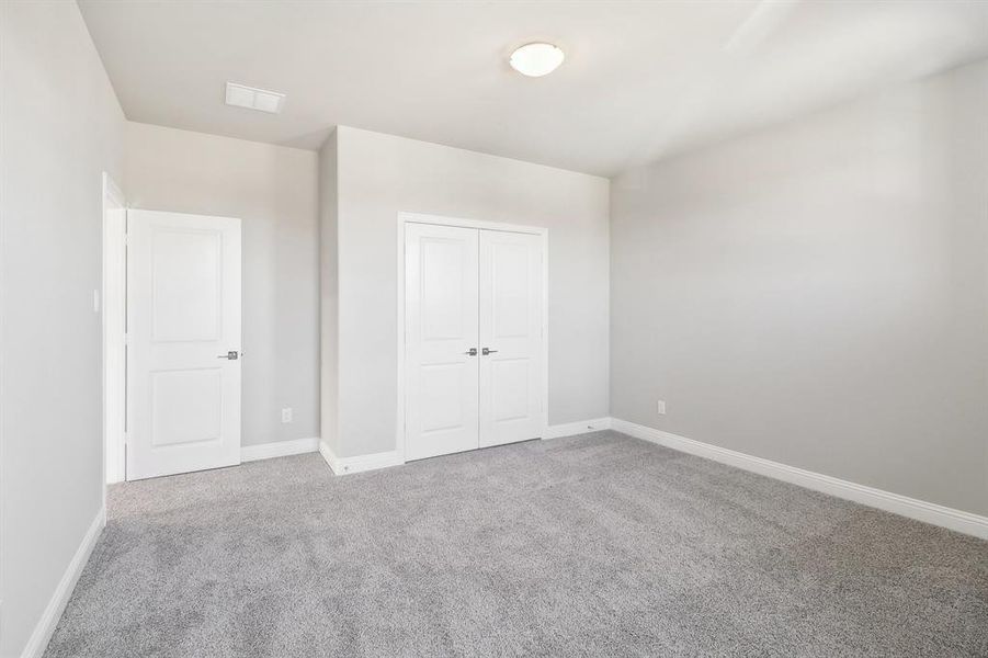 Unfurnished bedroom featuring carpet flooring and a closet