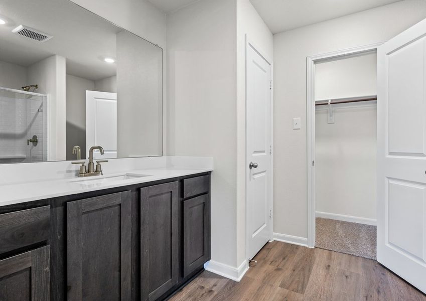 The master bathroom has a sprawling quartz vanity.