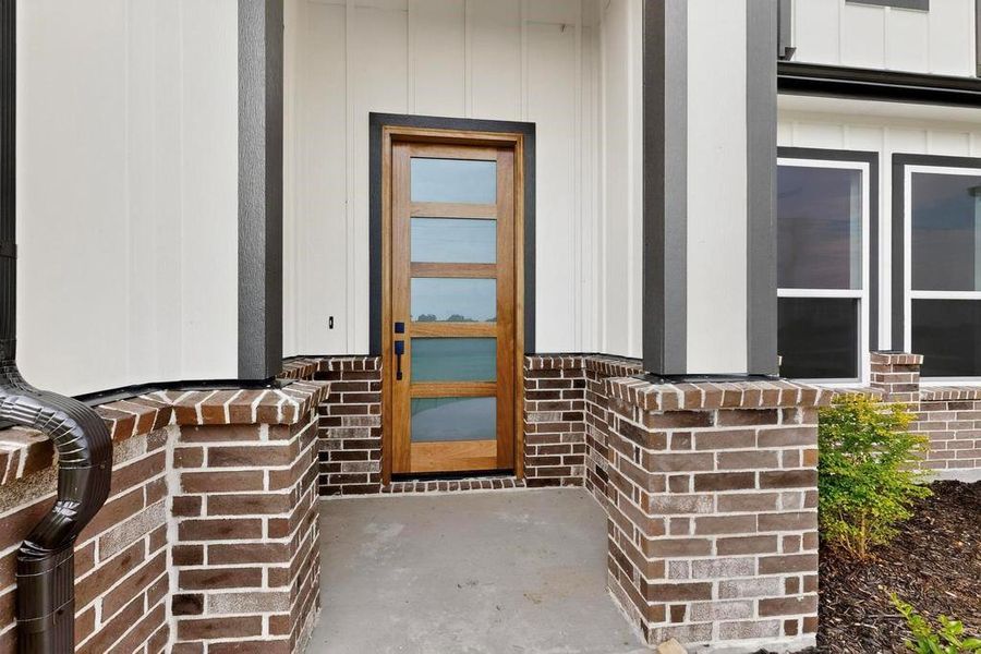 Entrance to property with brick siding and board and batten siding Entrance to property with brick siding and board and batten siding