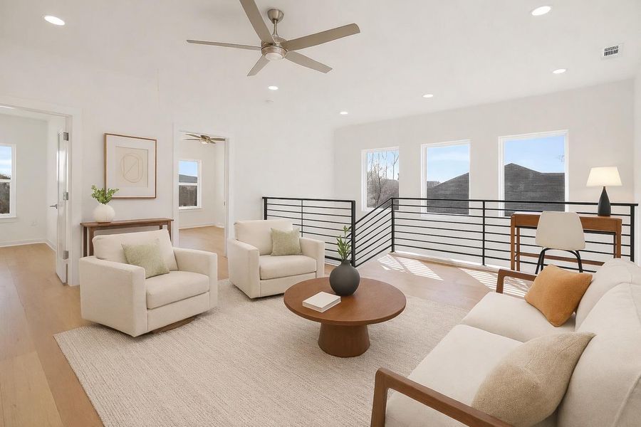 Living room featuring light wood-style floors, recessed lighting, and a ceiling fan