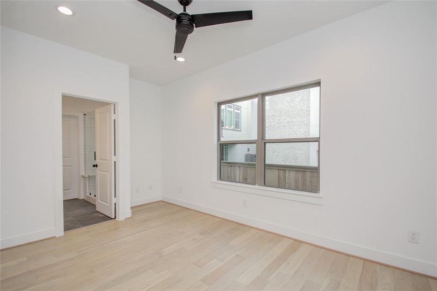 First floor bedroom with ensuite bath and big walk-in closet. Photos of similar completed home by same builder. Selections may differ.