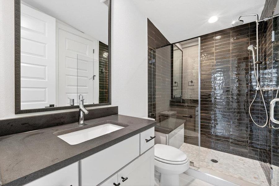 Bathroom with vanity and a stall shower
