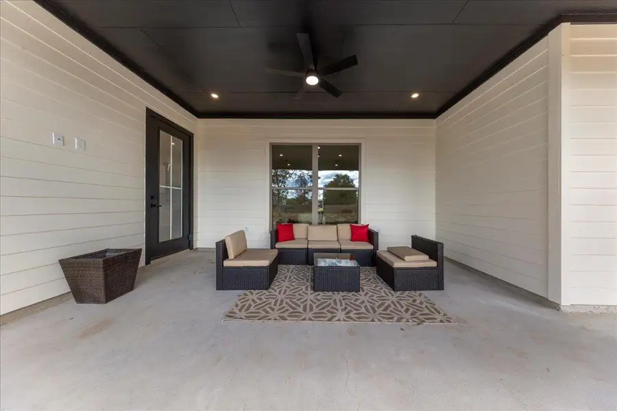 View of patio featuring a ceiling fan and an outdoor living space View of patio featuring a ceiling fan and an outdoor living space