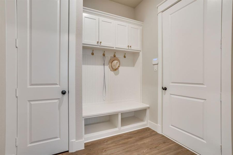 Built-in white cabinetry with a bench and storage cubbies