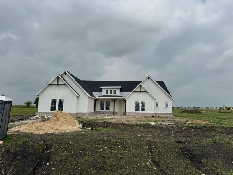 Modern farmhouse style exterior featuring white board-and-batten siding