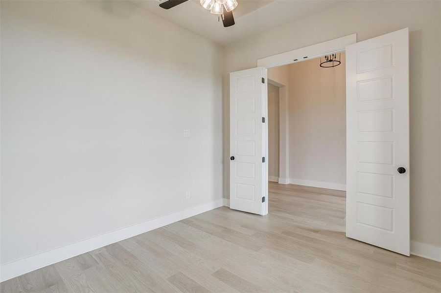 Unfurnished room featuring ceiling fan and light wood-type flooring