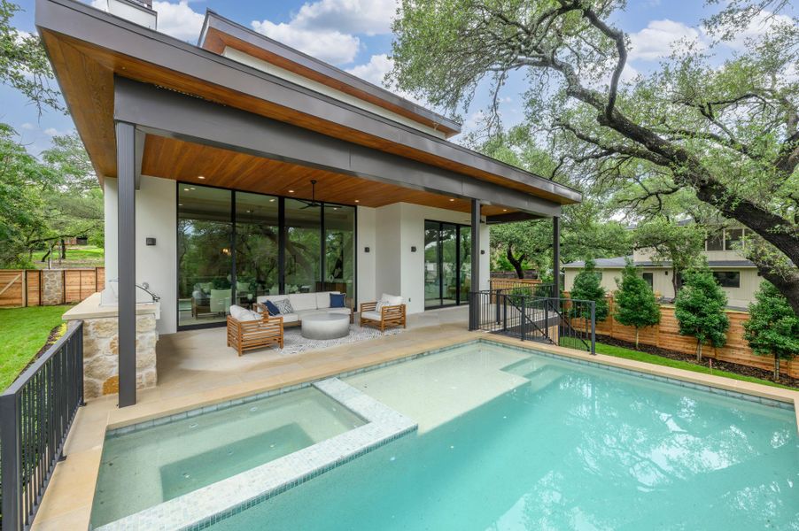An inviting backyard oasis offers a sparkling pool and spa with a spacious covered patio for outdoor relaxation. An inviting backyard oasis offers a sparkling pool and spa with a spacious covered patio for outdoor relaxation.