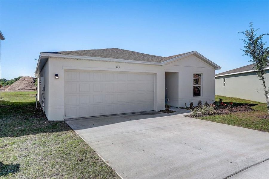 Front exterior of a new home in Lakewood Park, Fort Pierce, FL, highlighting curb appeal (Image 21). Front exterior of a new home in Lakewood Park, Fort Pierce, FL, highlighting curb appeal (Image 21).