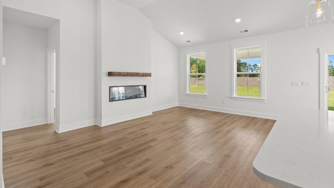 Cozy living area with 55" electric fireplace and large windows for natural light. Cozy living area with 55" electric fireplace and large windows for natural light.