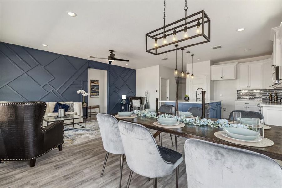 Dining space featuring ceiling fan and light wood-type flooring