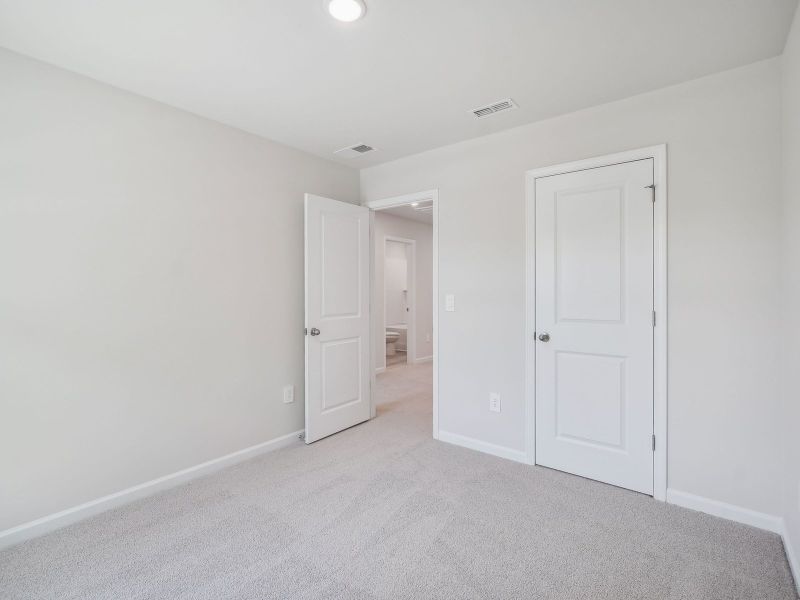 Two secondary bedrooms are ideally situated away from the primary suite.