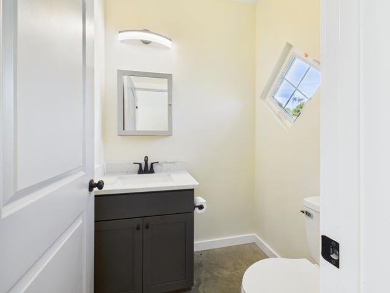 Before photo featuring vanity and concrete flooring