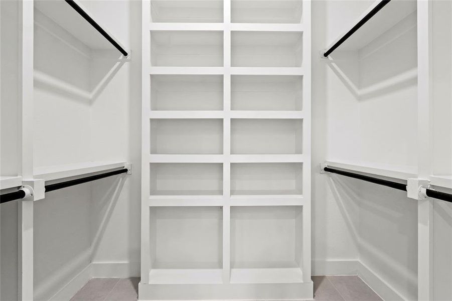Walk in closet featuring light tile patterned floors and elevator