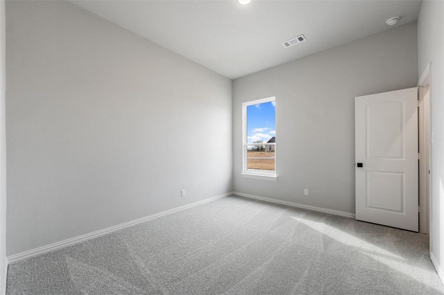 Unfurnished room featuring carpet floors and baseboards Unfurnished room featuring carpet floors and baseboards