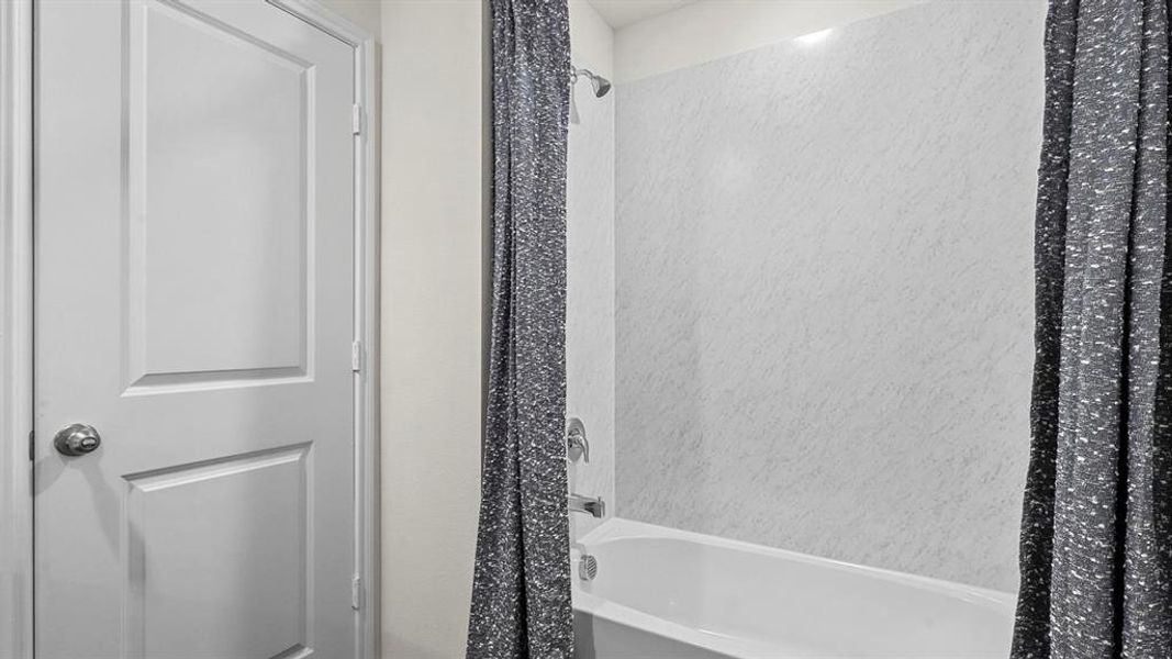 Bathroom with shower / bathtub combination with curtain