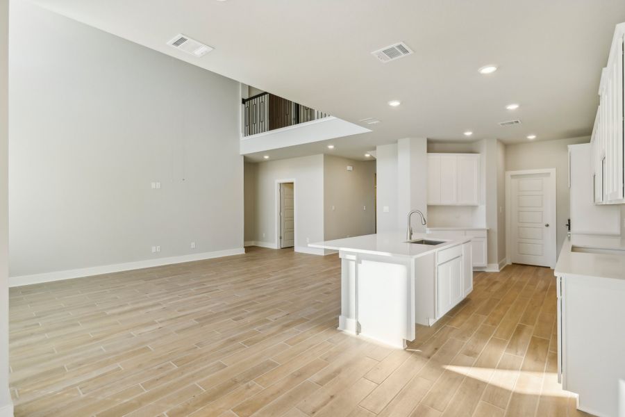 Living room and kitchen in the Cedar floorplan at a Meritage Homes community.