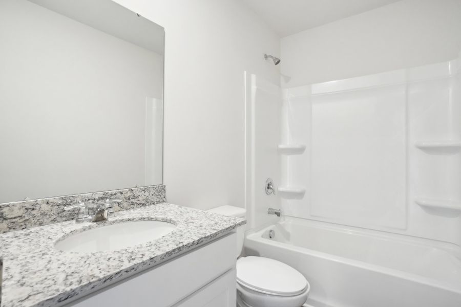 A bathroom with a marble countertop. A bathroom with a marble countertop.