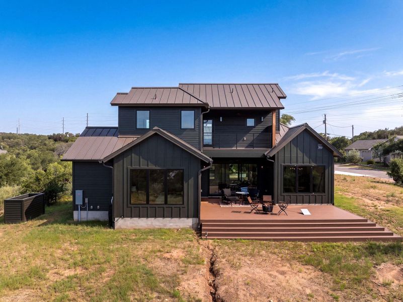 An expansive multi-level deck extends from the back of this modern two-story home.