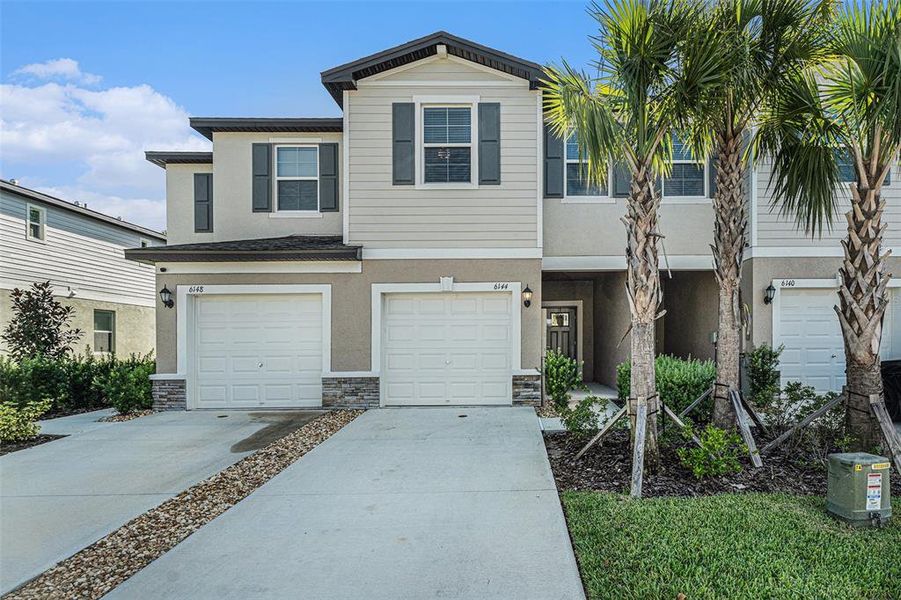 Front exterior of a new home in , Land O' Lakes, FL, highlighting curb appeal (Image 1). Front exterior of a new home in , Land O' Lakes, FL, highlighting curb appeal (Image 1).