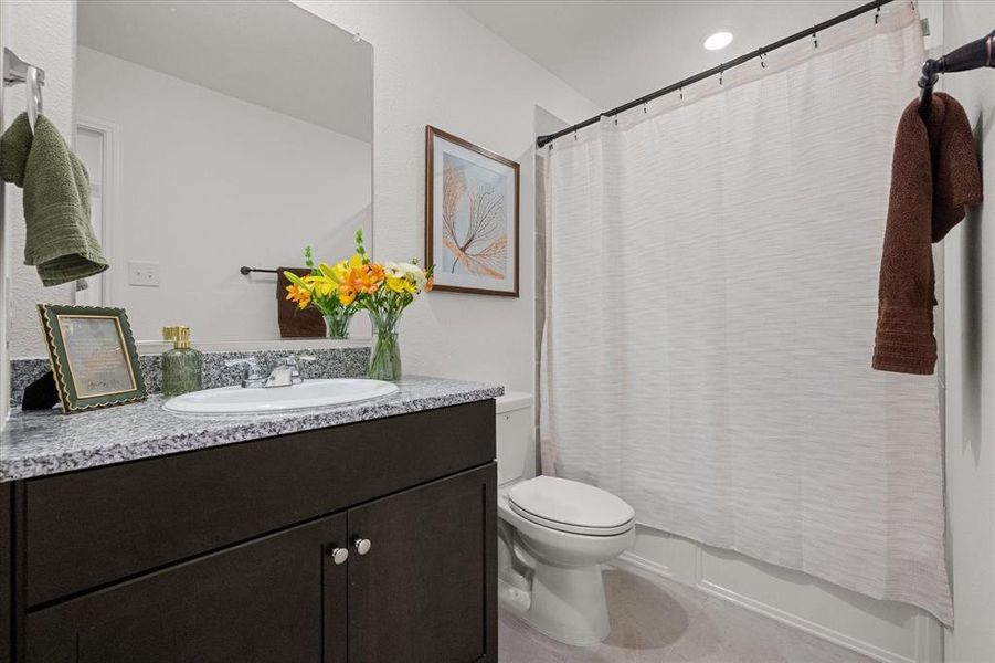 Full bath featuring vanity and shower / bath combination with curtain