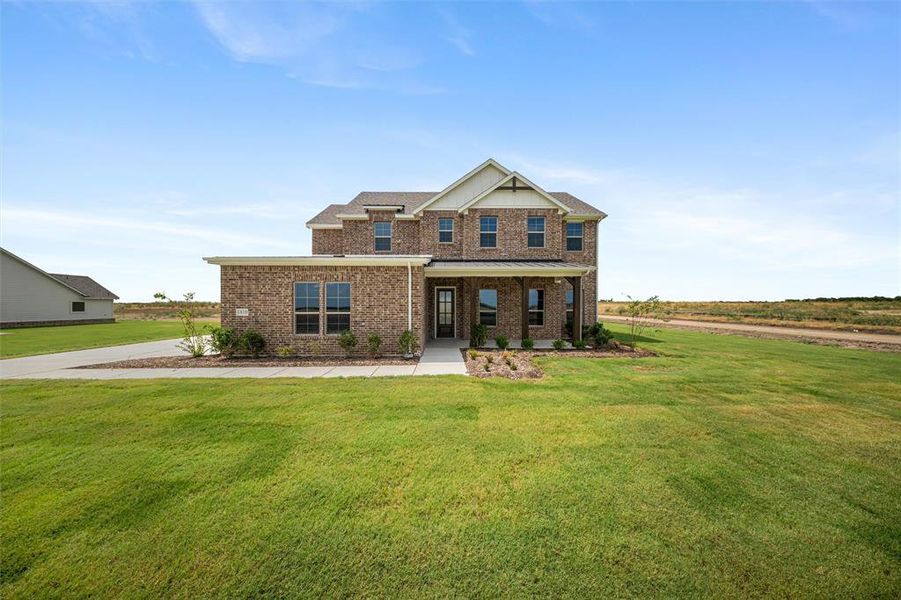 Craftsman inspired home featuring brick siding, a front yard, and a porch Craftsman inspired home featuring brick siding, a front yard, and a porch