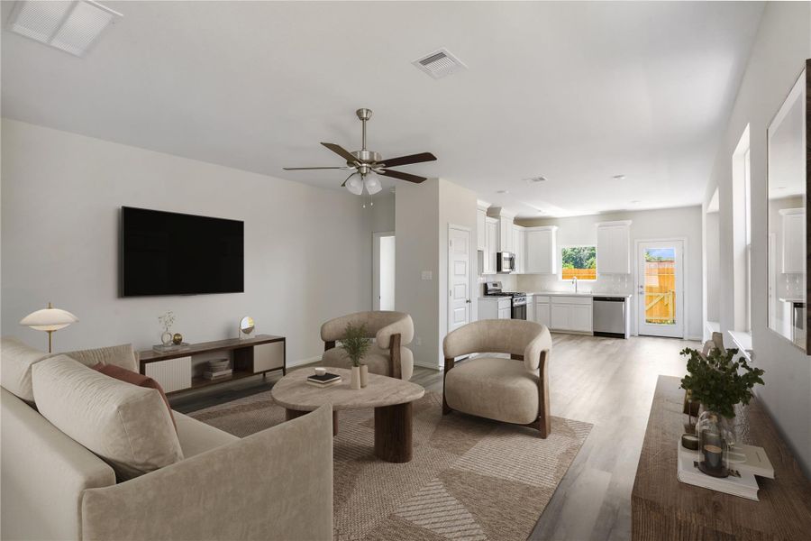 Upon entering is the spacious living room with ceiling fan.