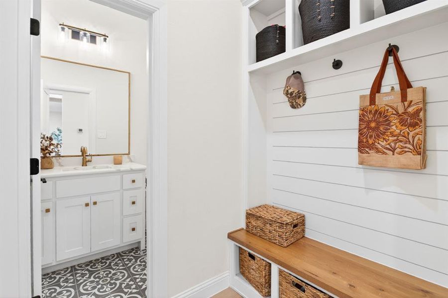 Mudroom featuring a sink and baseboards Mudroom featuring a sink and baseboards