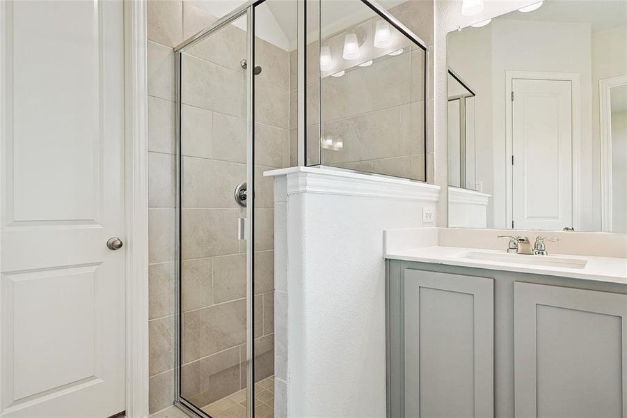 Bathroom featuring vanity and an enclosed shower