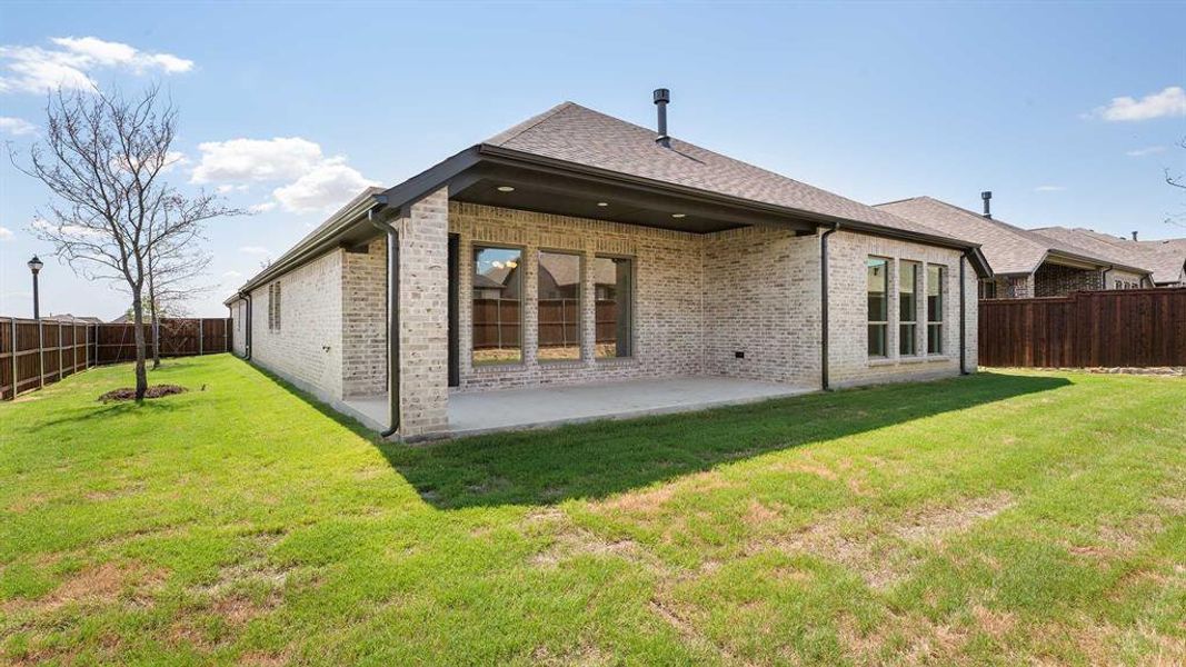 Front exterior of a new home in Reunion 50', Rhome, TX, highlighting curb appeal (Image 1). Front exterior of a new home in Reunion 50', Rhome, TX, highlighting curb appeal (Image 1).